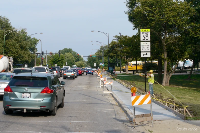 several cars are parked on the side of a city street