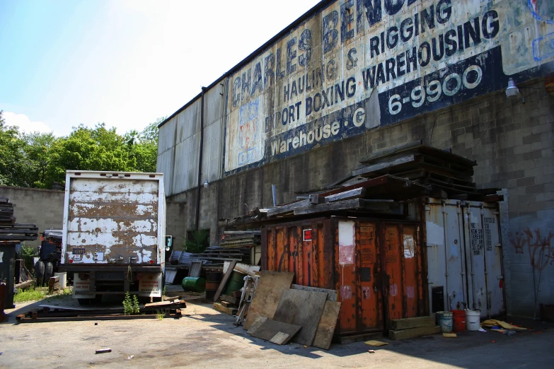 a dilapidated building has large advertising on it