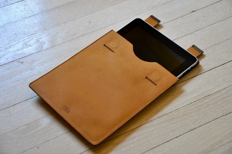 a tablet sitting on top of a leather case