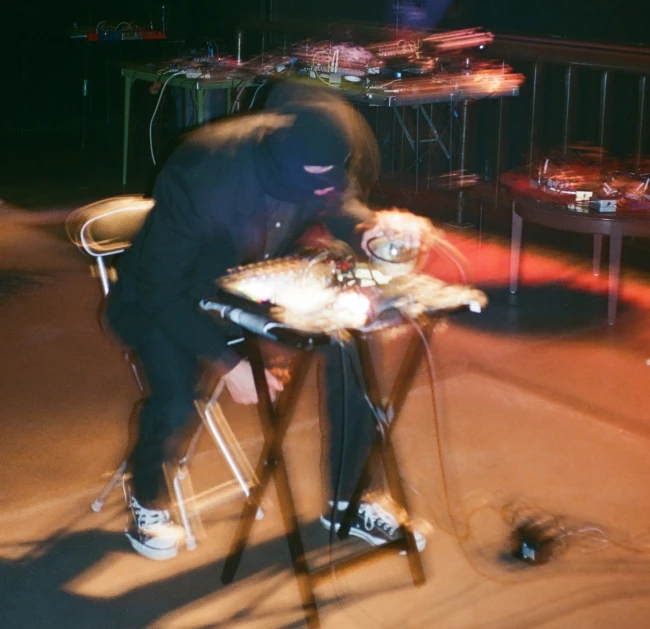 a person standing on a chair holding a stuffed animal