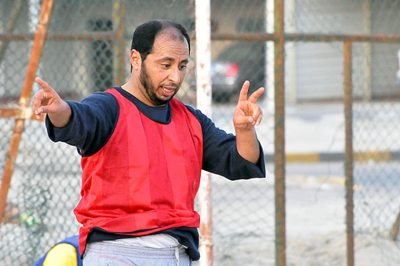 a man with his hands up while standing