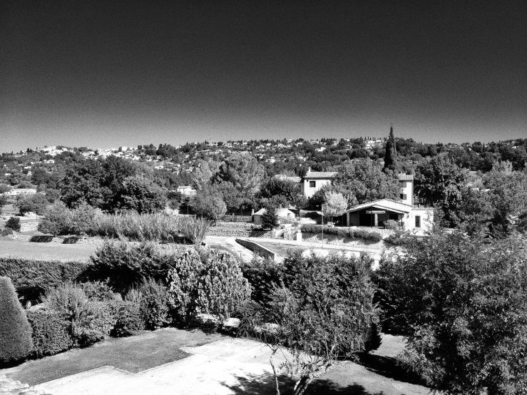 the view from a hill shows the buildings and trees