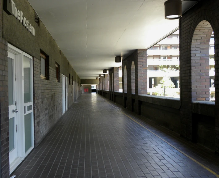 a large empty brick building next to two buildings