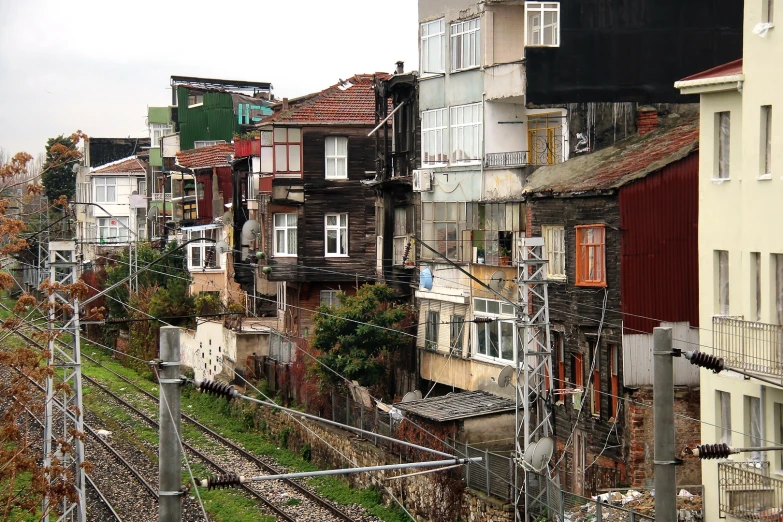 old residential houses line the side of a railroad track