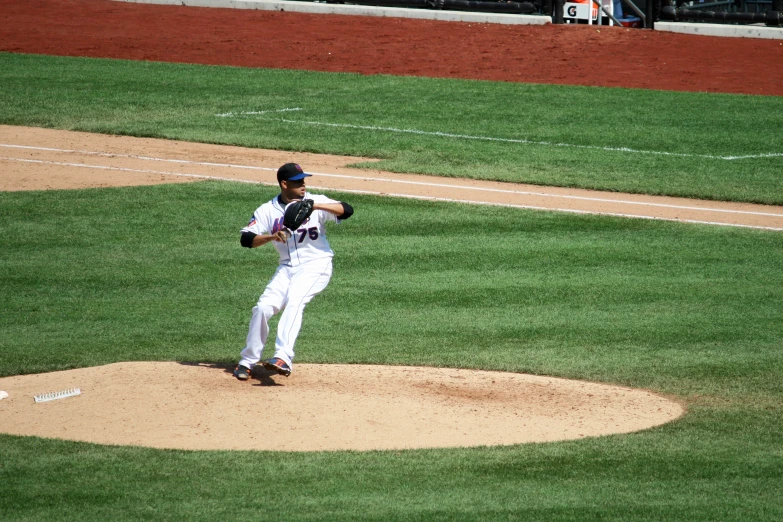 a baseball player throwing the ball from the mound