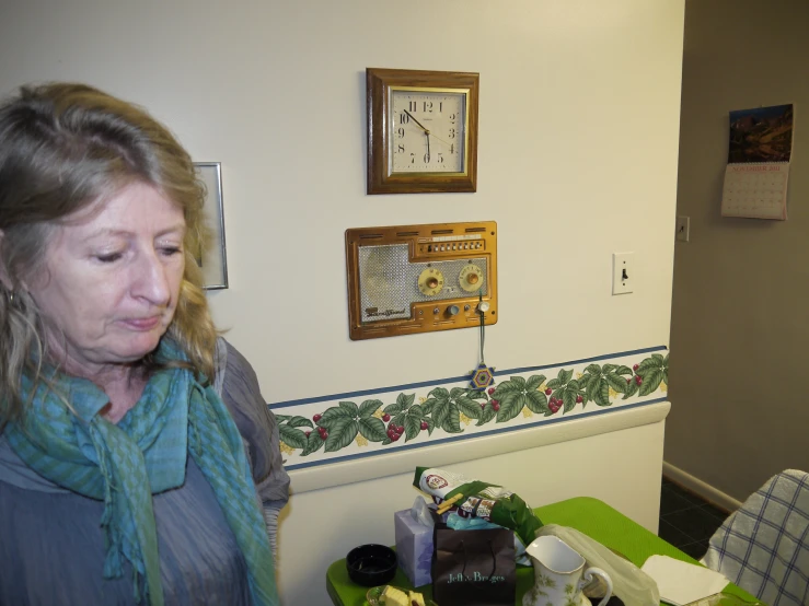 a woman is standing in a room with a wall clock