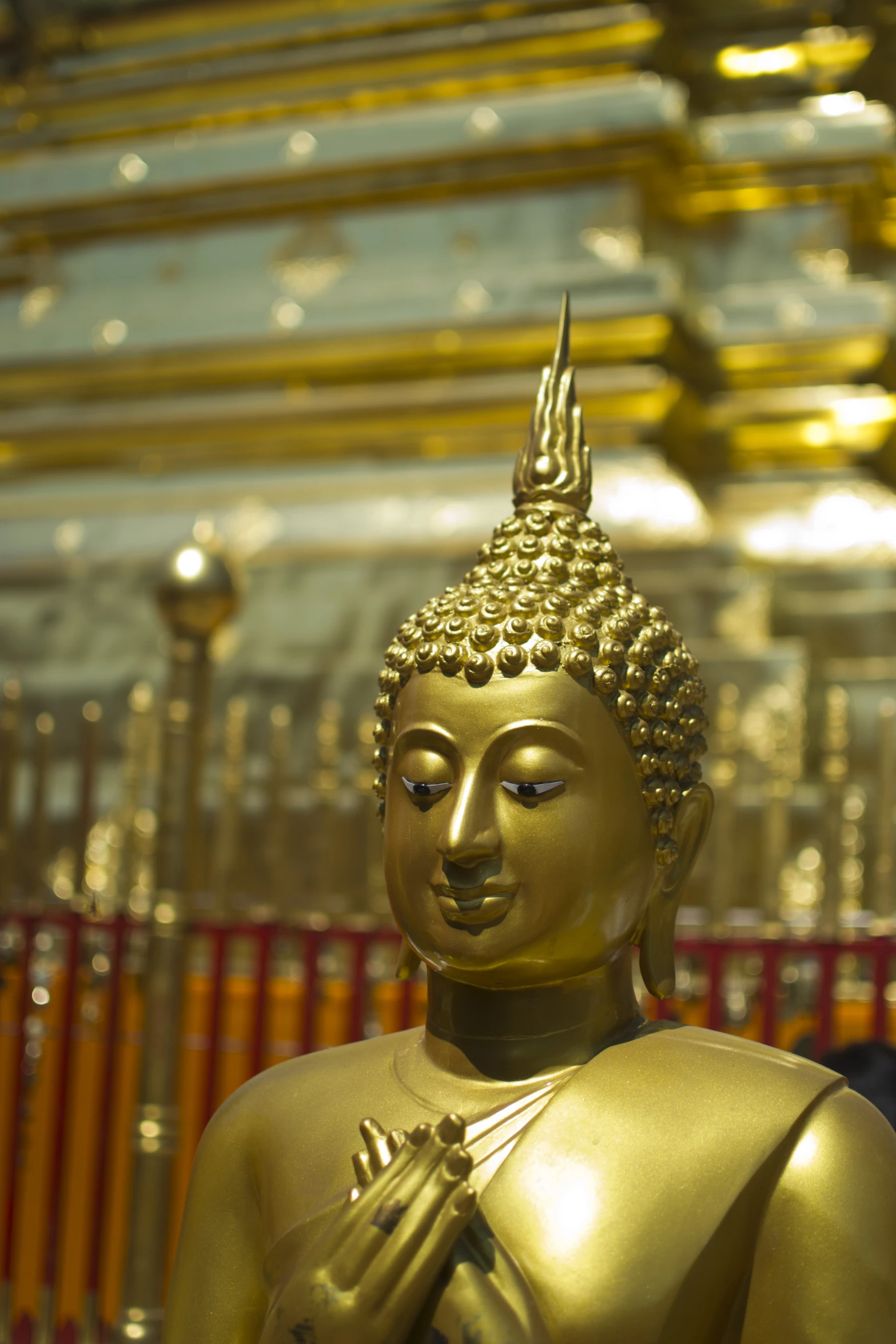a golden statue of a buddha is sitting
