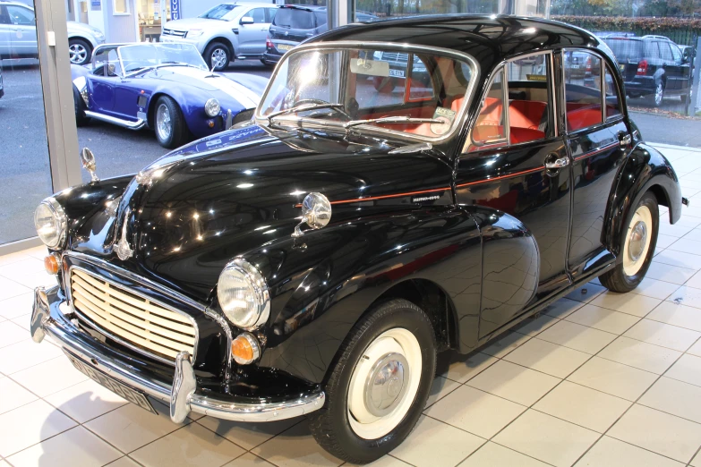 a vintage car sits parked inside of a showroom