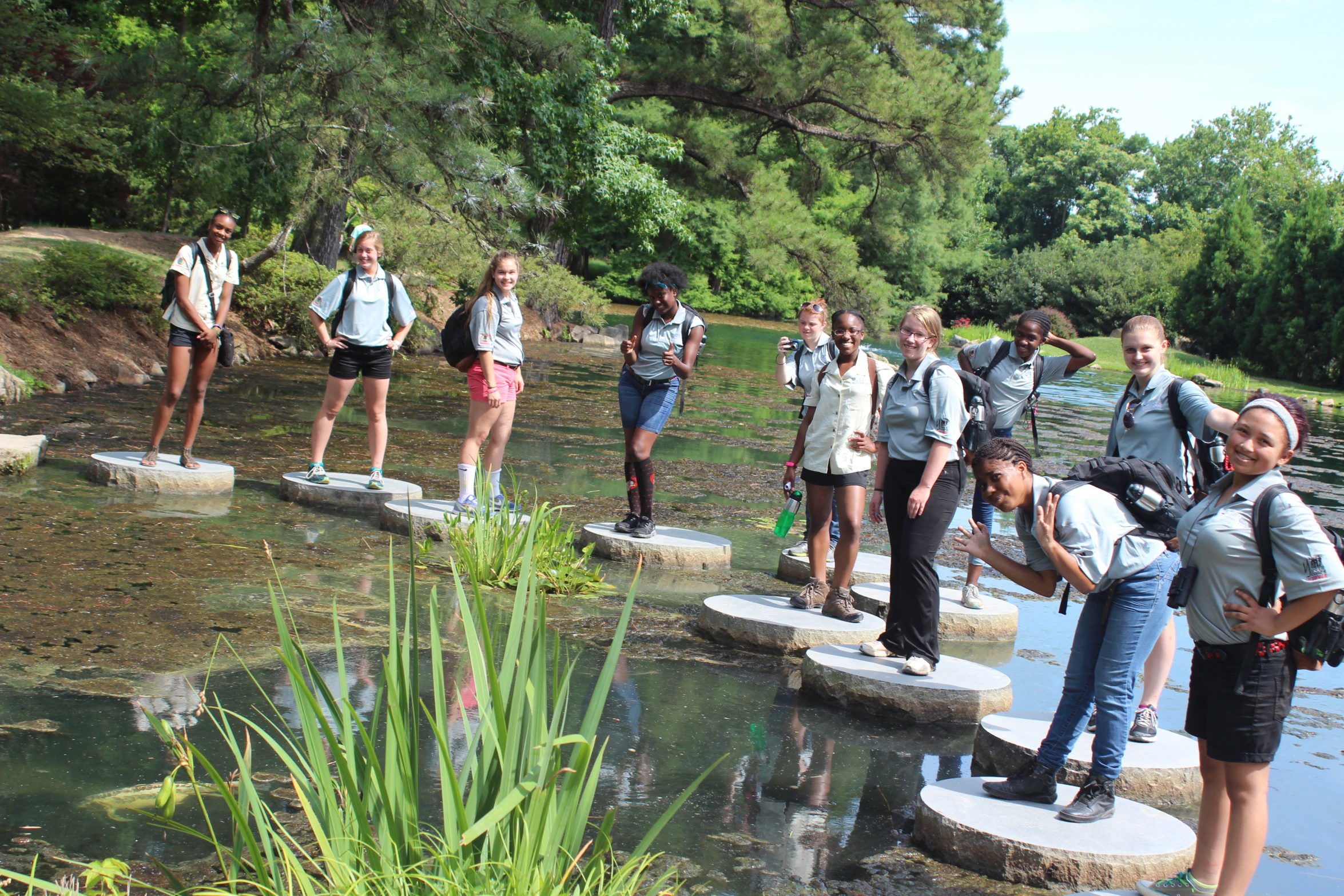 a group of people that are standing on stepping stones