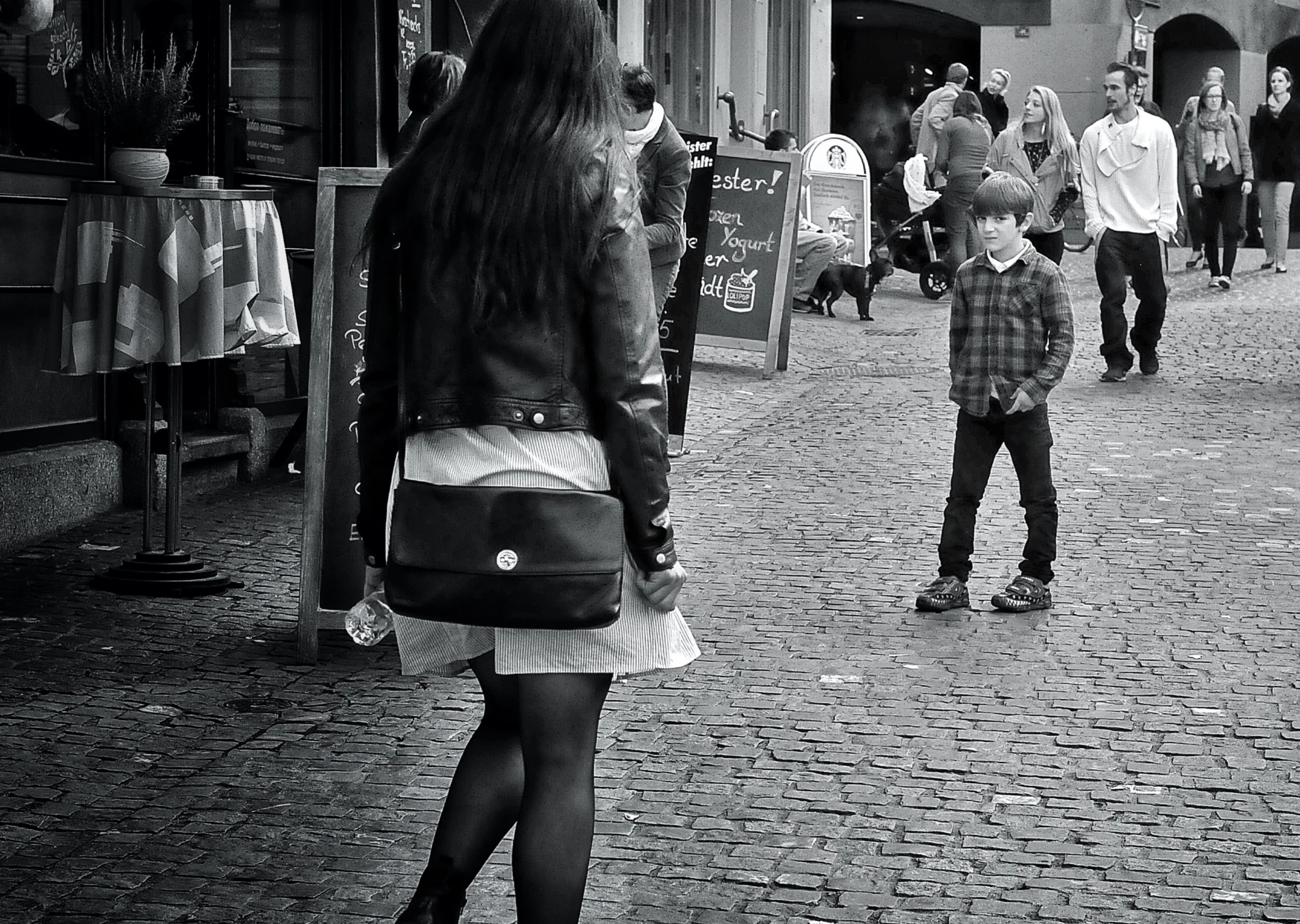 the woman is walking next to a small boy