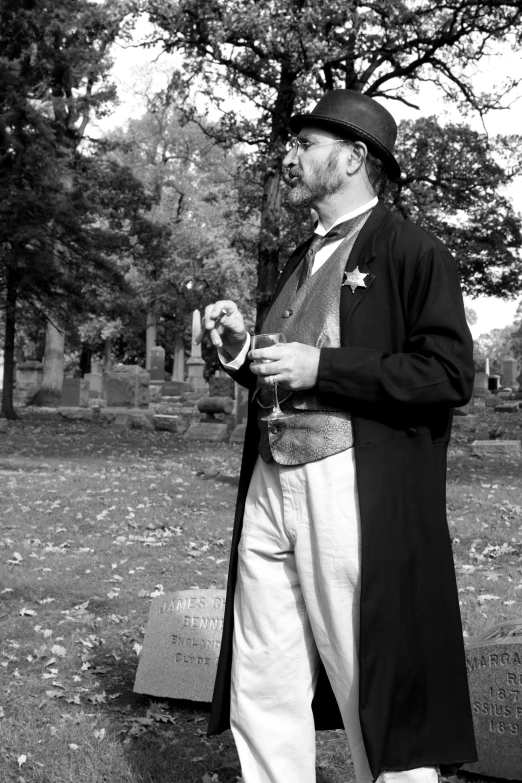 black and white image of a man wearing trench coat