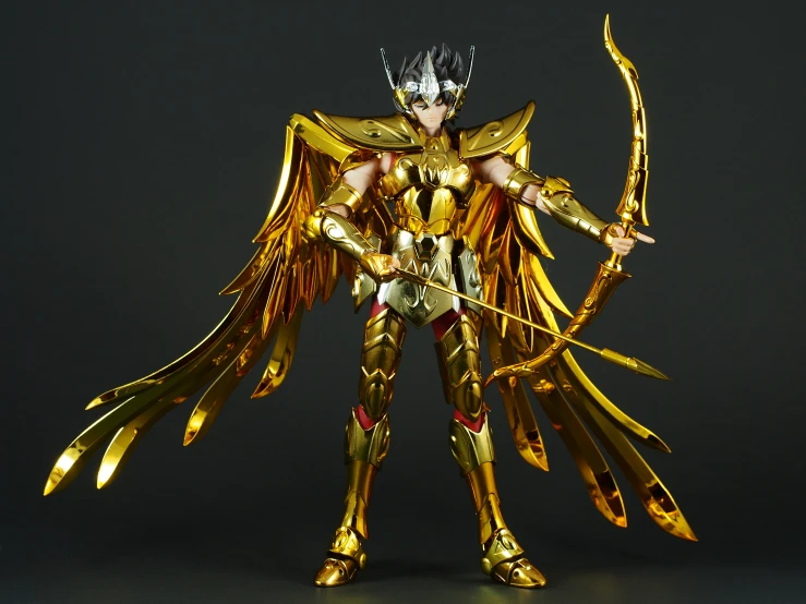 an action figure is posed as gold on black background