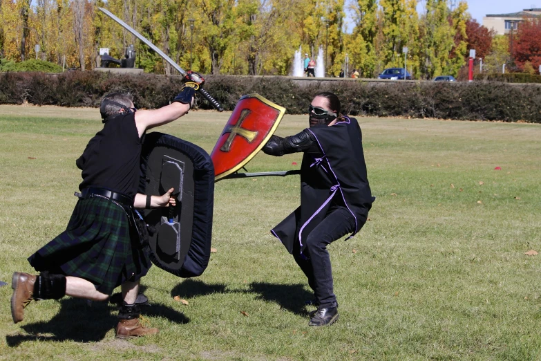 two men dressed as knights fighting with each other