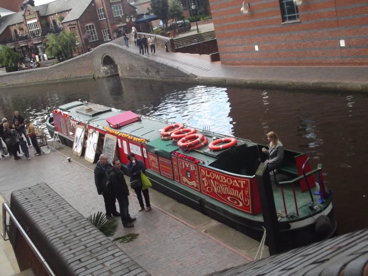 a group of people stand on top of a boat