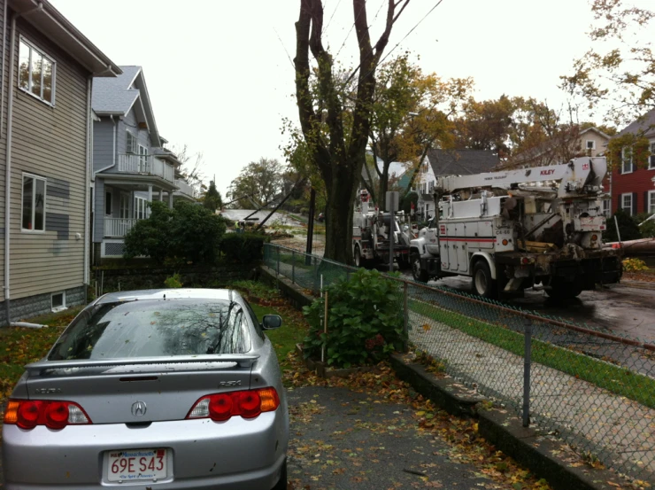 large truck next to parked car near residential homes