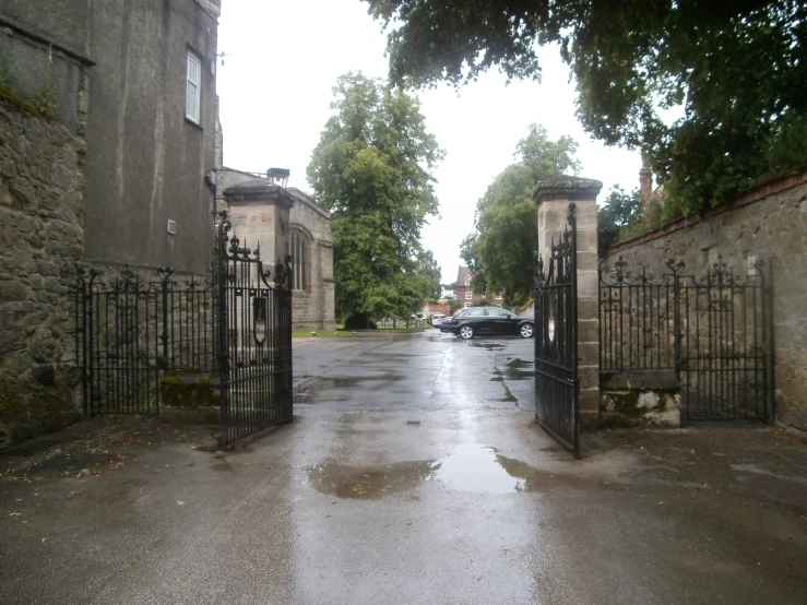 an empty driveway and gated area in the middle of town