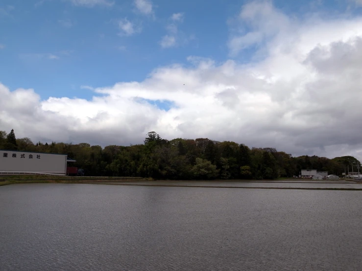 the water is clear and empty, under some clouds