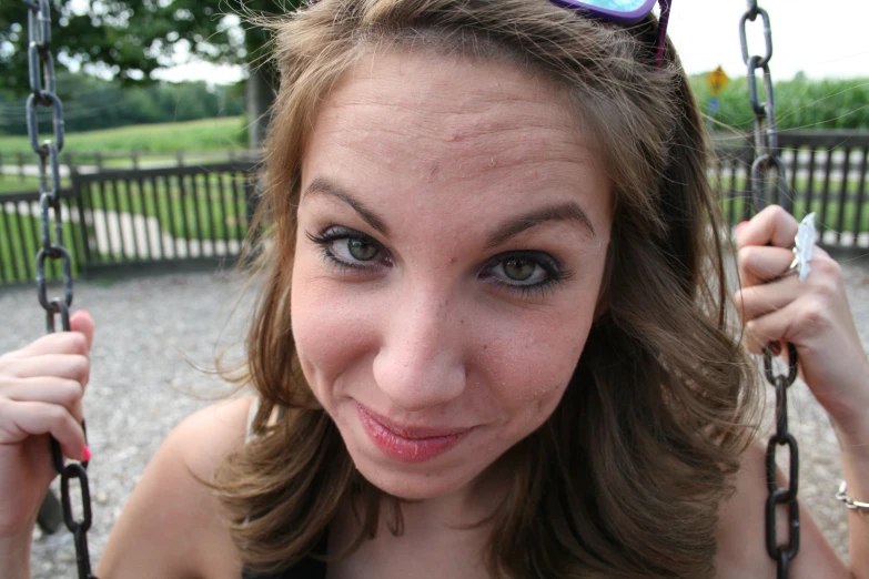 a woman on a playground looking at the camera