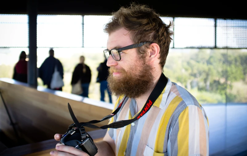 a man holding an old fashioned camera at the event