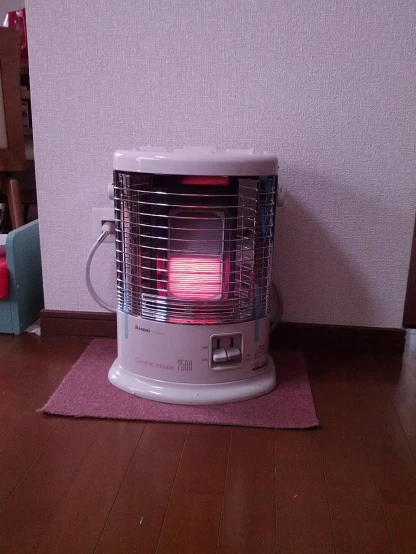 an electric heater is sitting on the ground in the living room