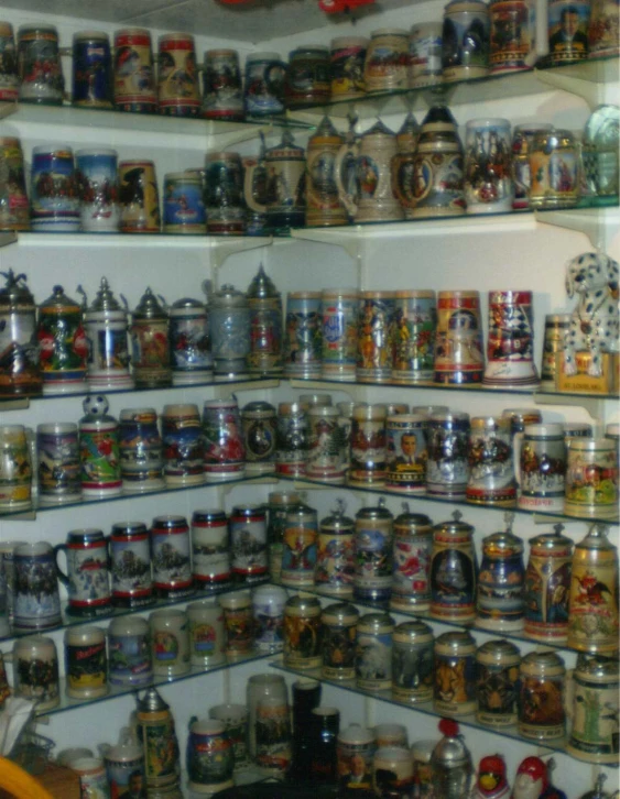 the shelves in this store filled with items like jars, mugs and tin cans