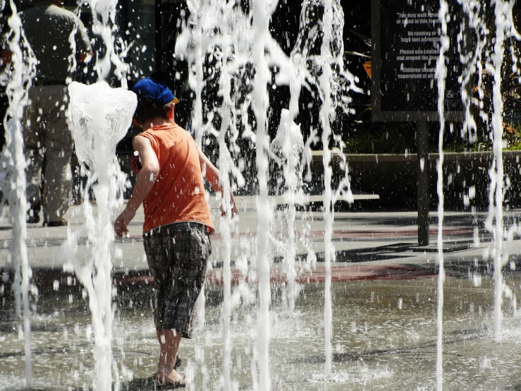 a  is playing in the water fountains