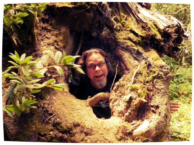 a man that is peaking out of a hole in the ground