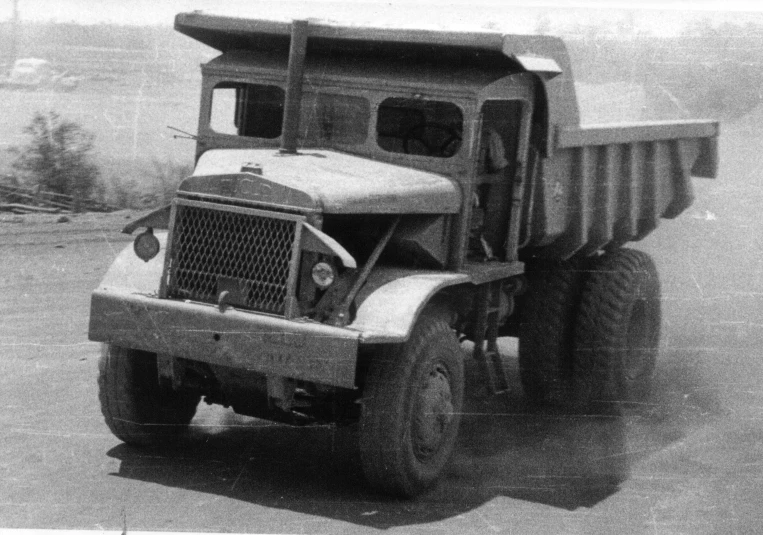 an old dump truck sitting on the side of the road