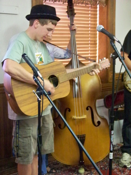 two men stand next to each other while playing music