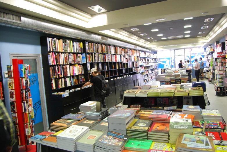 the woman is shopping through the books at the bookstore