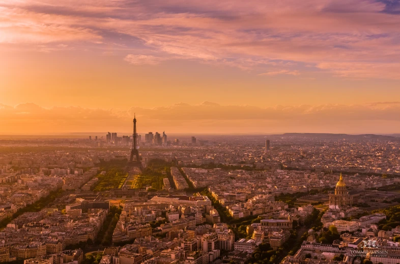 the view of a city with tall buildings in sunset