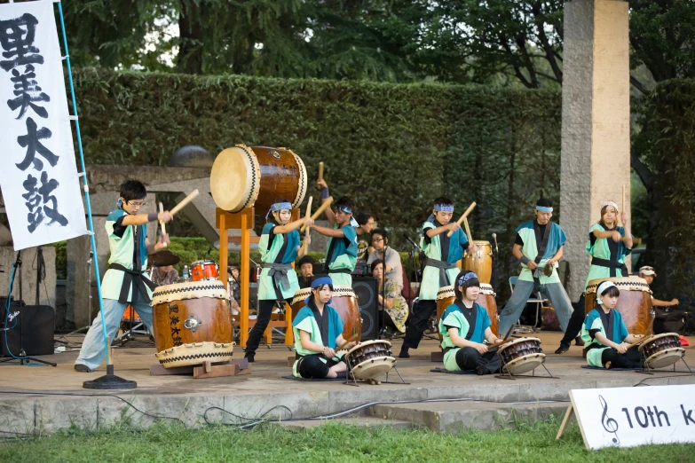 some s with drums playing in front of a building