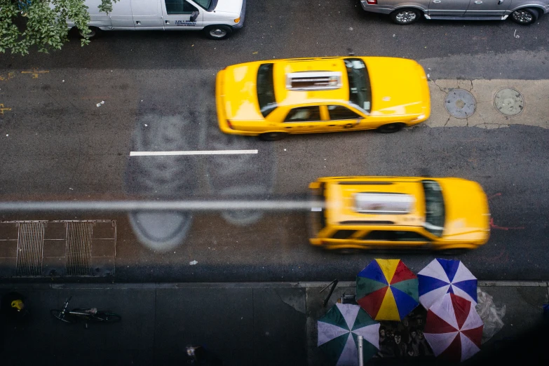 a view from above of a parking lot with three yellow cars