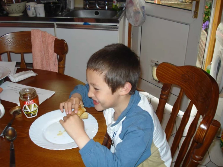  eating a sandwich at a kitchen table
