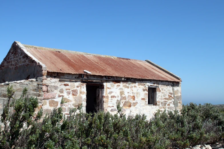 an old building with a rusty tin roof