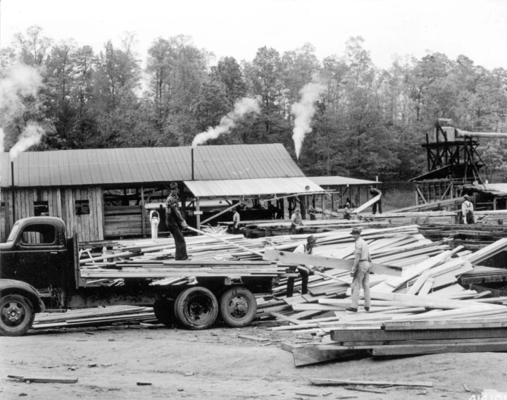 the men are standing in the yard, building an industrial area