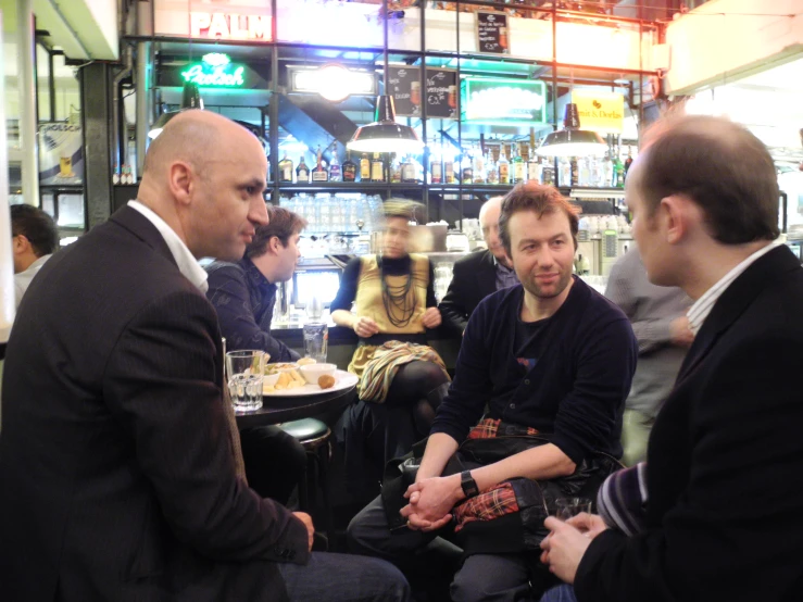 people sitting and talking at a restaurant