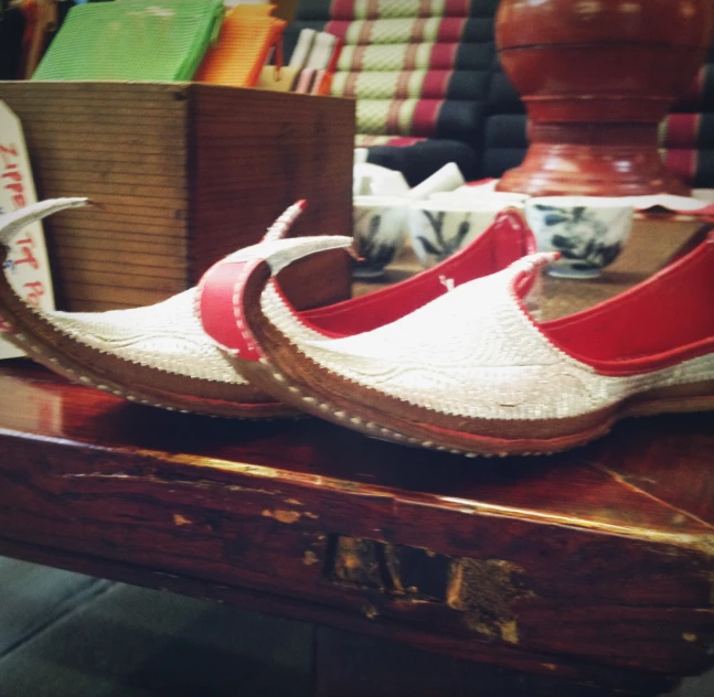 a close up of two pairs of shoes with wood soles