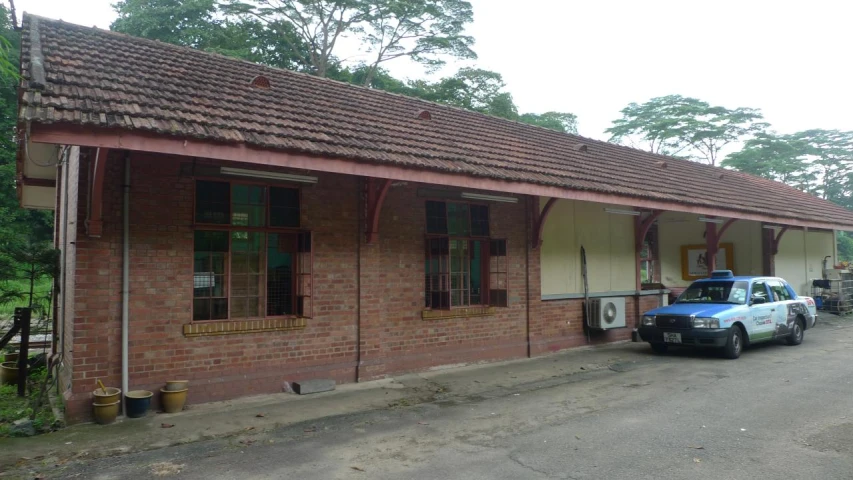 an old brick building with a car parked in front