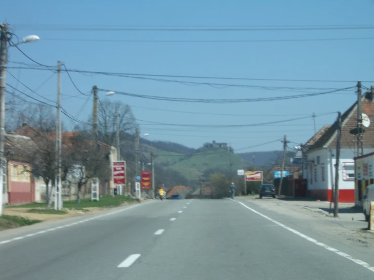 a deserted street with telephone poles on either side