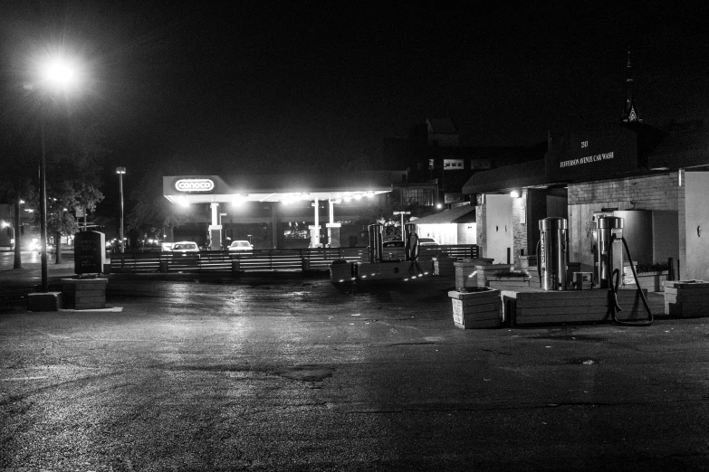 a black and white image of a gas station
