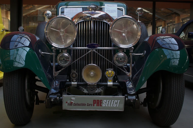 the front view of a fancy car parked in front of a building