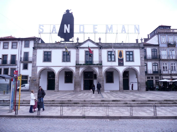 a group of people standing outside of a large building