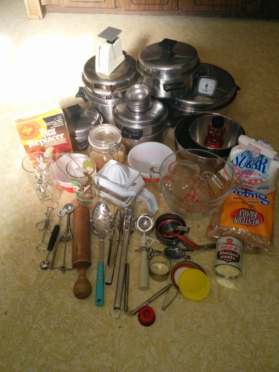 various kitchen supplies sit together on the ground