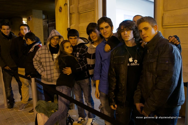 a group of people standing around each other