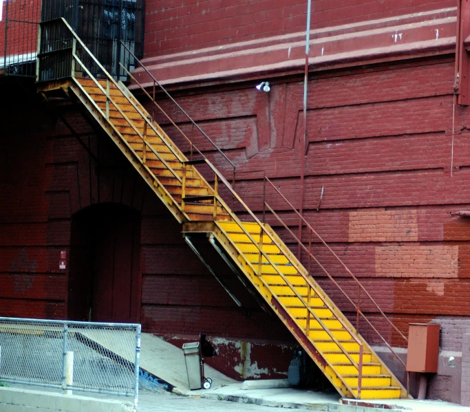 some yellow steps that are outside of a red building