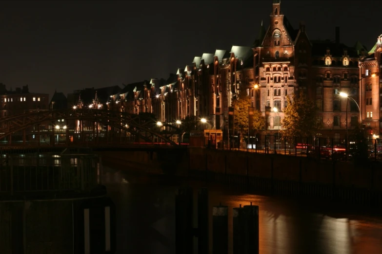 buildings in an old city at night with lights on