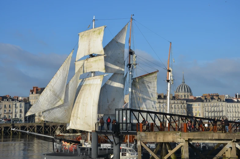 an old sailing vessel is out in the water