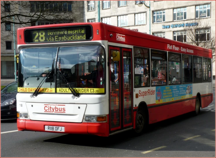 bus in city with red frame near cars