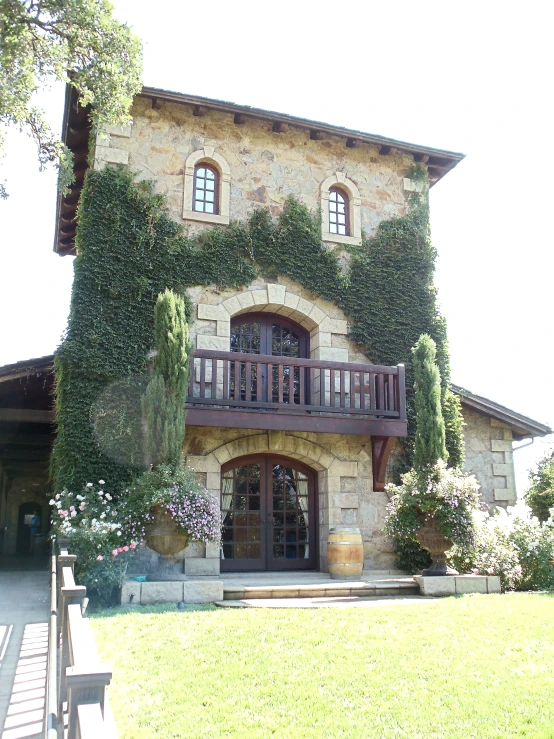 a tall building with lots of green plants surrounding it